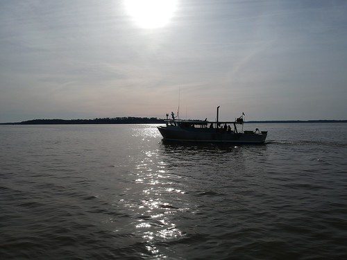 Photo of boat on a bay, in silhouette