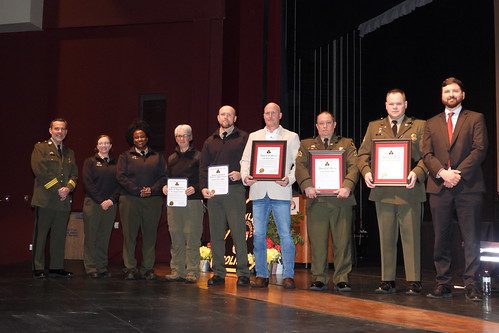 Photo of Cpl. Brian Hunt, A/Sgt. Mark Miller, and Ofc. Andrew Cummins receiving an Award of Merit; Suzanne Weber and Ranger Tyler Walker receiving a Superintendent's Letter of Appreciation. Also pictured A/Ltc. Brian Rathgeb (left), Ranger Rachel Temby (second from left), Park Service Director Angela Crenshaw (third from left) and Sec. Josh Kurtz (right).